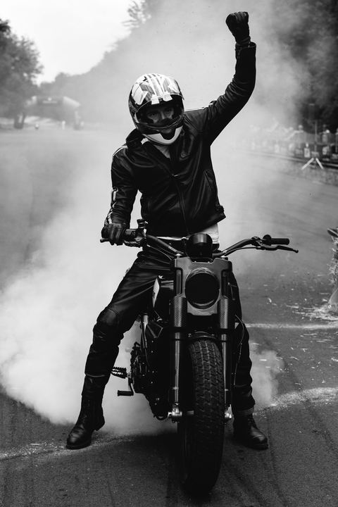Pugno alzato nel fumo del burnout, bianco e nero